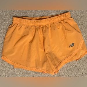 Womens New Balance athletic shorts, tangerine color, size small